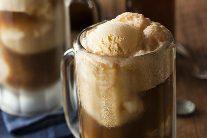 A close up image of a Kahlua vanilla root beer float, with a second one in the background