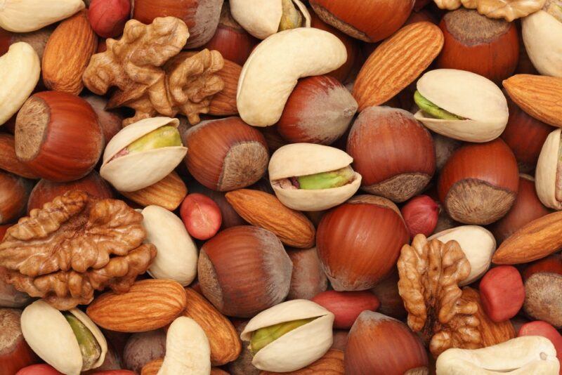 A collection of different nuts, including walnuts, almonds, cashews, and pistachios