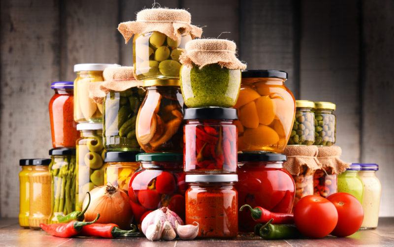 A large collection of food in jars, much of which has been pickled or fermented