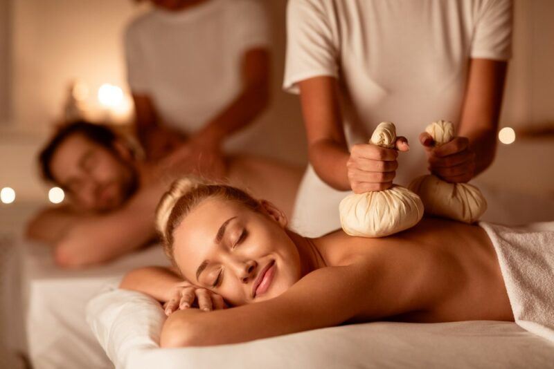 A happy couple getting massages at a resort