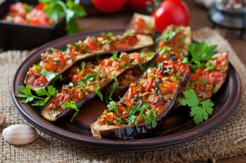 A large plate of sliced and stuffed eggplants