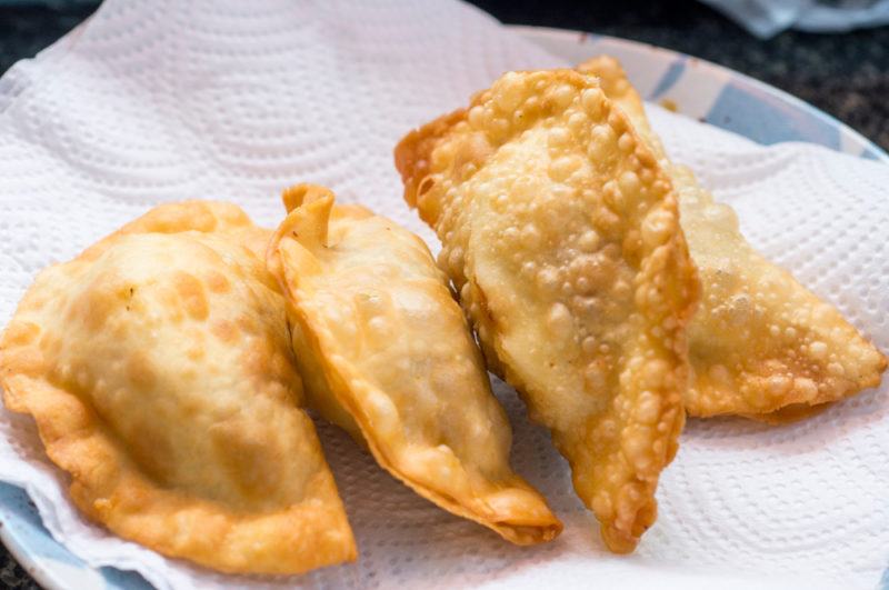 A plate with a paper towel and a few pieces of banh goi