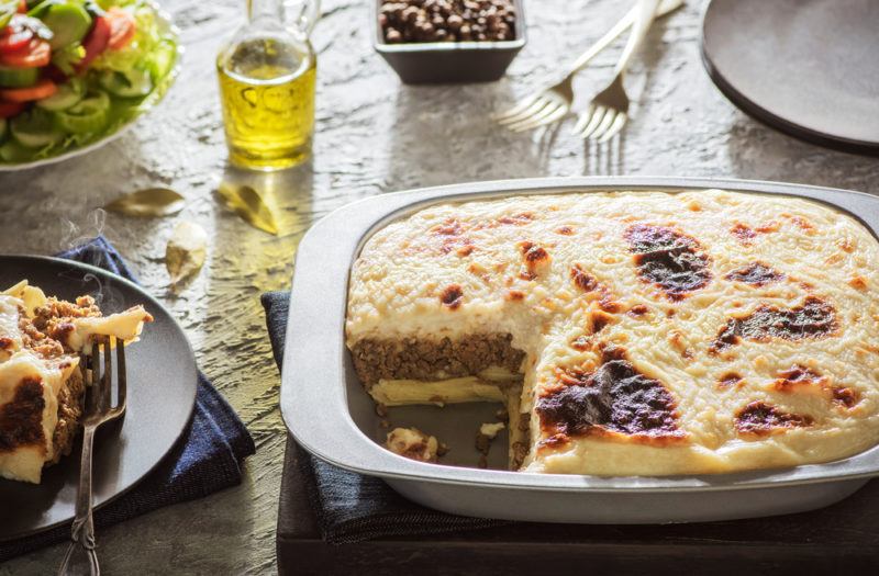 A dish of macaroni bechamel on a table with seasonings