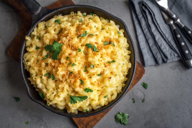 A cast iron frypan filled with macaroni cheese