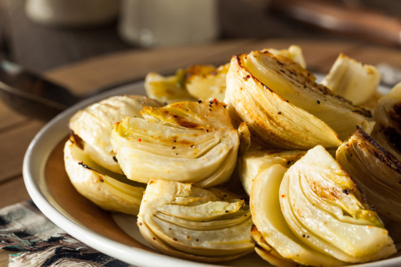 A dish of fennel pieces that have been roasted or baked