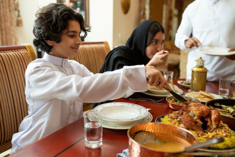 A family sitting down to eat together at the end of Ramadan