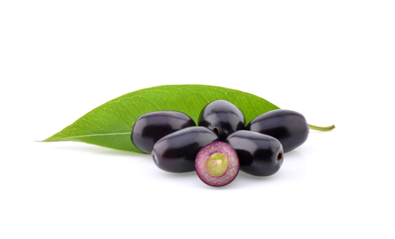 A few Indian plums isolated on white, against a leaf