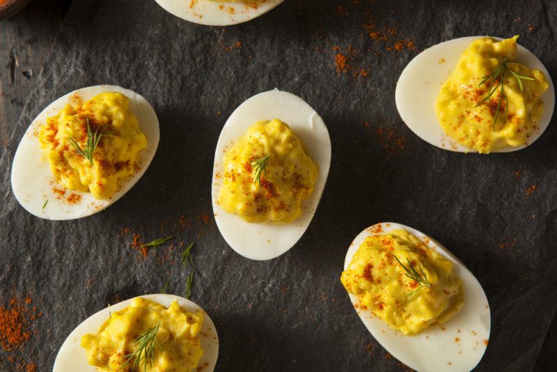 A black table with a handful of fresh deviled eggs