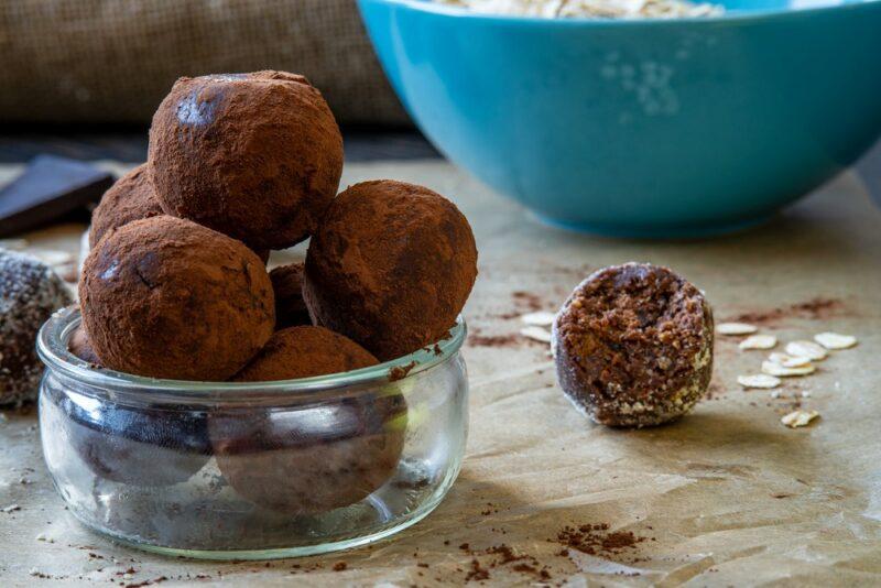 A small glass dish with chocolate protein bites or keto fat bombs