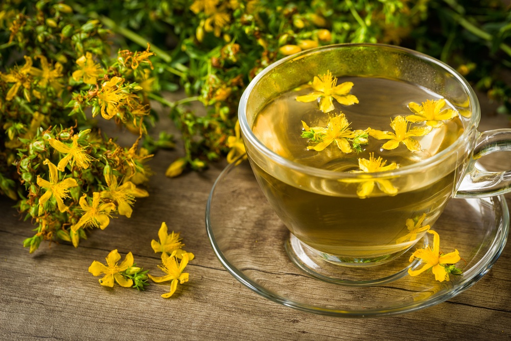 A glass mug filled with St John's Wort and St John's Wort