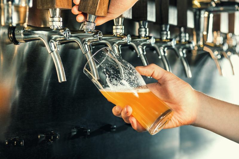 A glass of beer being poured from a tap