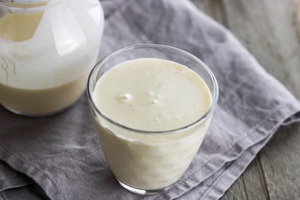 A cloth with a jug of fermented milk and a glass of the milk