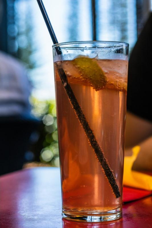 A tall glass of lemon lime and bitters with a straw