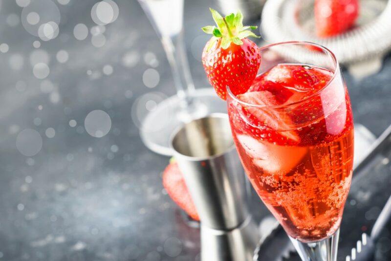 A glass of prosecco made with strawberries