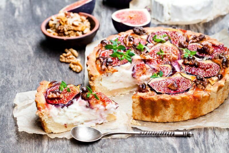 A tart or pie made with goat cheese, with figs and walnuts on top