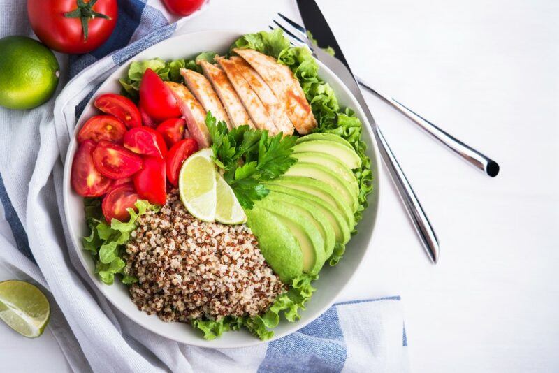 A white bowl containing a healthy meal that has carbs and fat