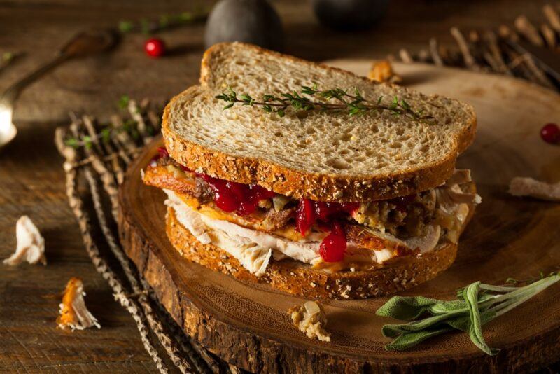 A wooden board with a fall salad made using rustic bread