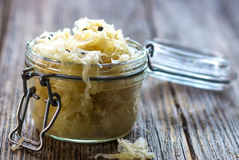 A jar of sauerkraut on a wooden table