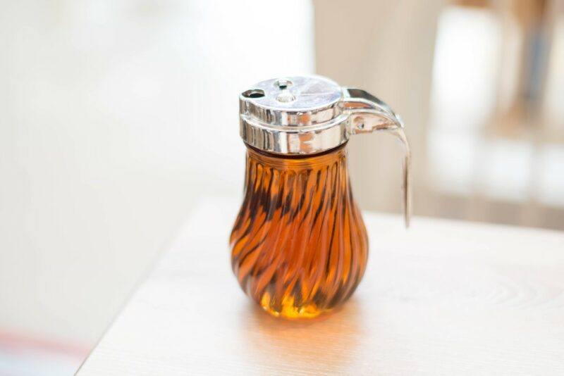 A glass jug of maple syrup