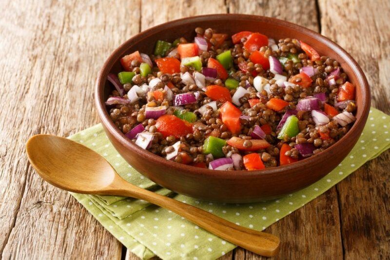 A large brown bowl containing a lentil salad