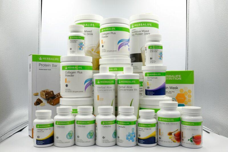 A large pile of different Herbalife products