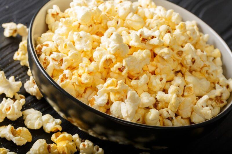 A large black dish with freshly prepared popcorn