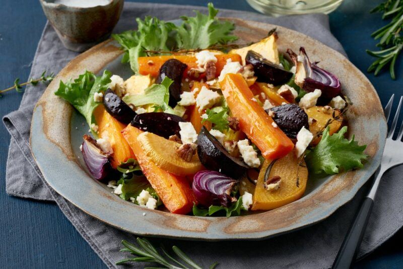 A plate with roasted vegetables, including carrots and beets