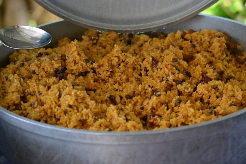 A large gray pot of arroz con gandules  which involves rice and pigeon peas