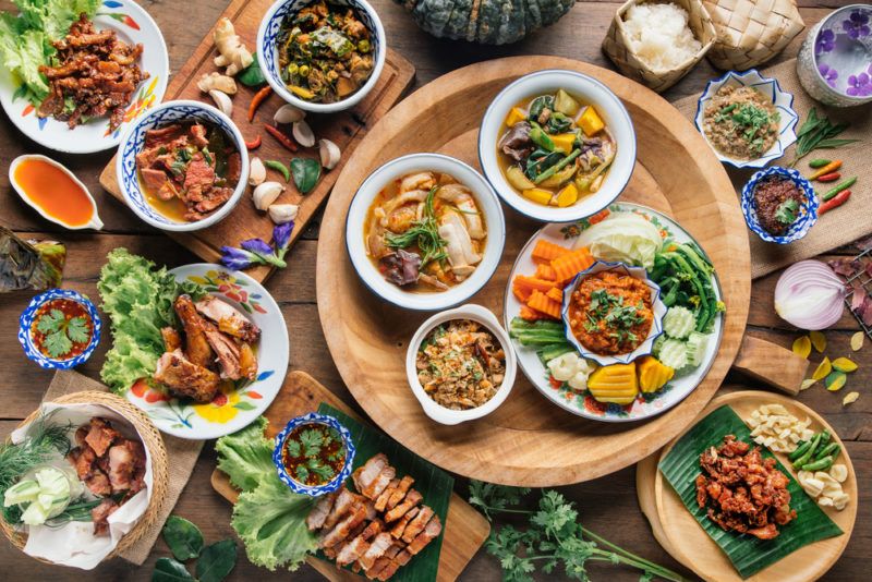 A large selection of Thai foods on a table