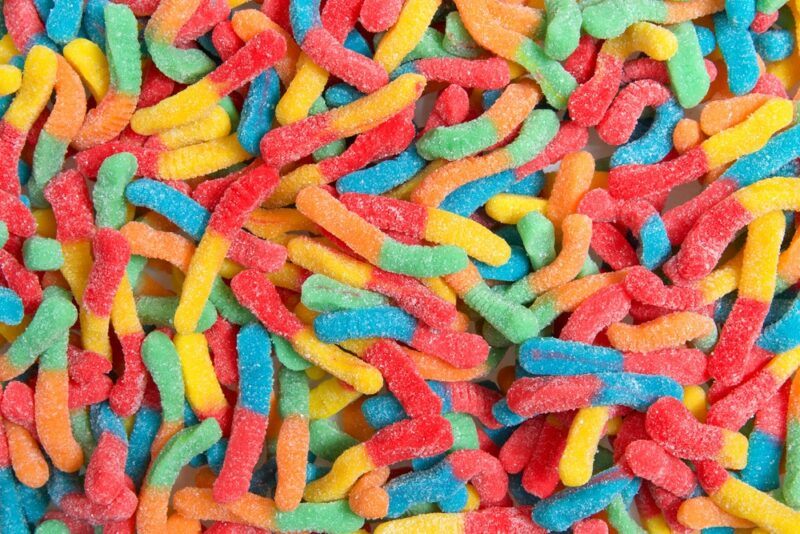 A large number of brightly colored sour gummy worms