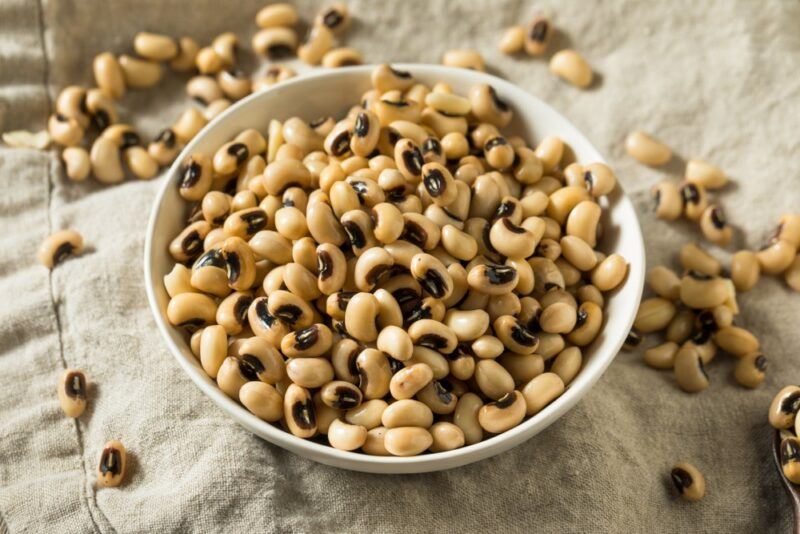 A large white dish filled with black eyed peas