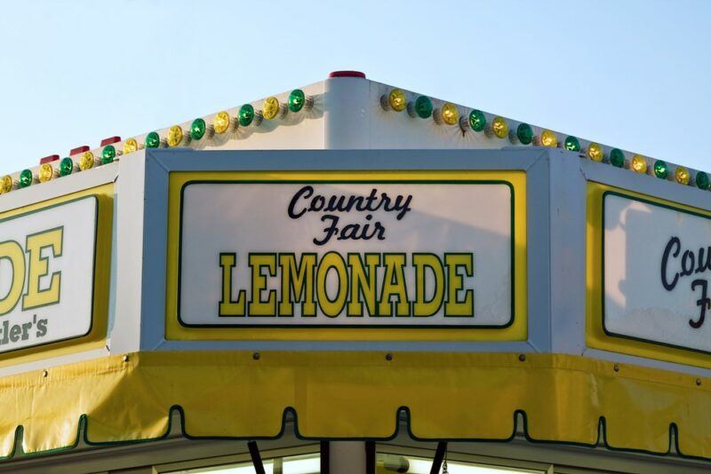 A sign for a lemonade stand at a county fair