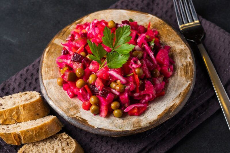 A meal made with pickled beets on a table next to bread