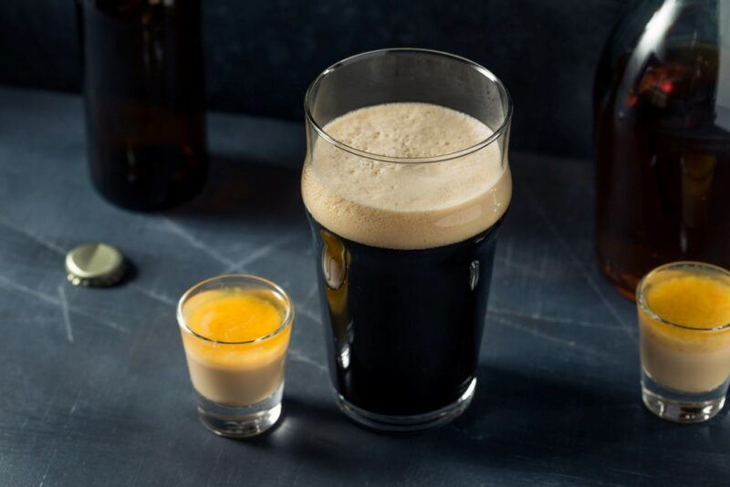 A mug of Guinness, next to two shot glasses, which each contain Irish cream and coffee liqueur