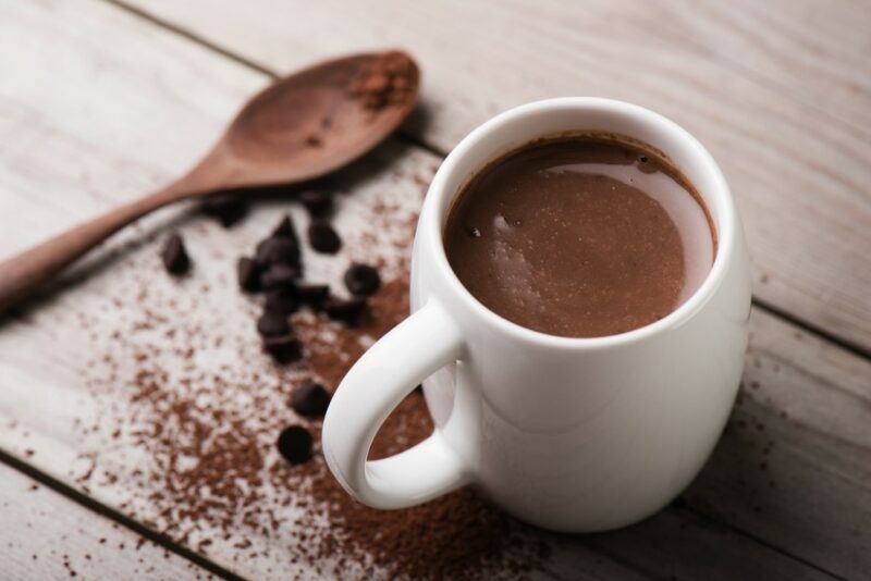 A white mug containing hot chocolate that has been spiked with red wine