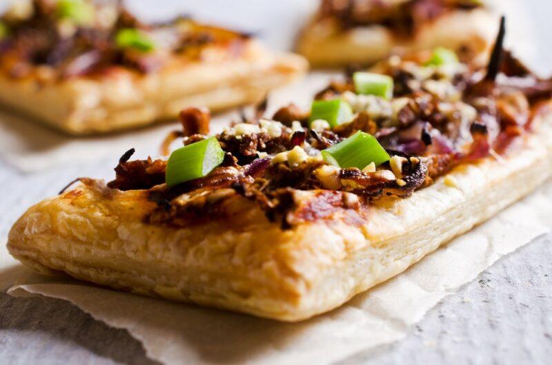 Three mushroom tarts on a cloth, made to be served at a picnic