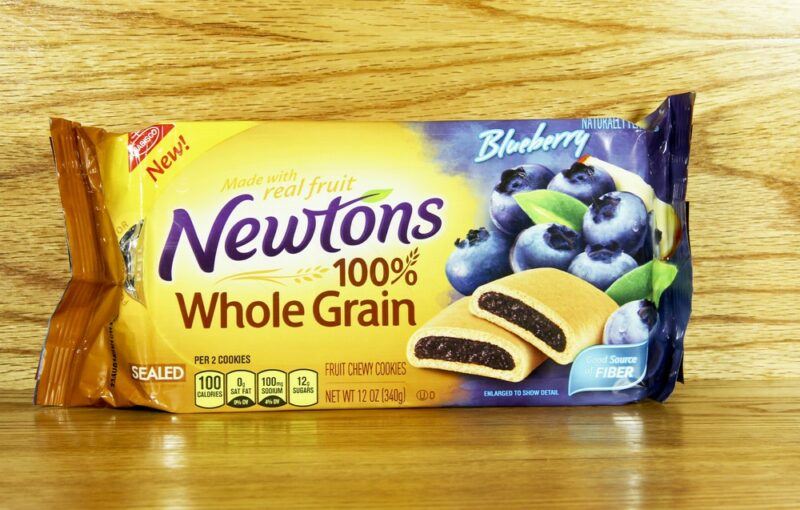 A single package of whole grain Fig Newtons against a wooden background