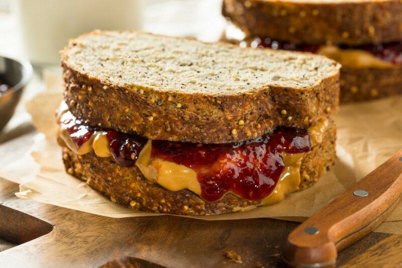 Two peanut butter and jelly sandwiches made using thick bread