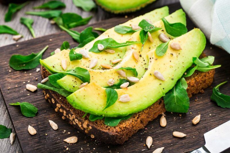 A piece of toast with sliced avocados