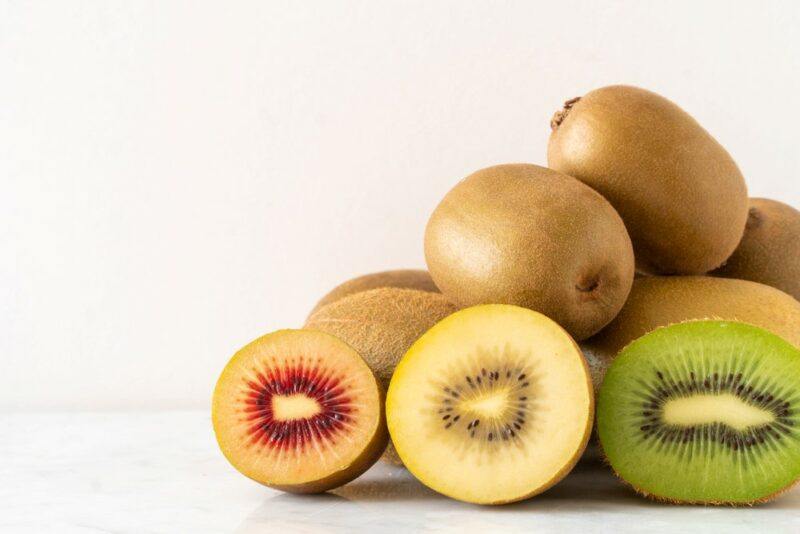 Fresh kiwis in three different types, red, yellow, green