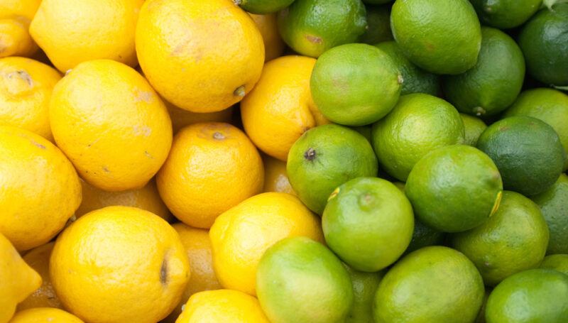 A pile of lemons and another of limes