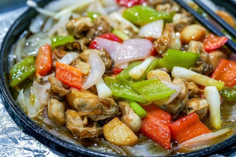 A large plate of cooked vegetables and smoked oysters