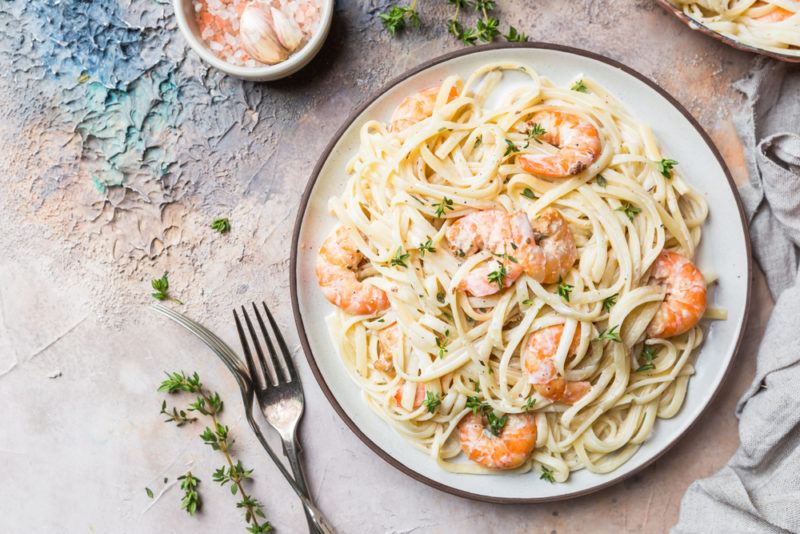 A blue and white dish with shrimp pasta