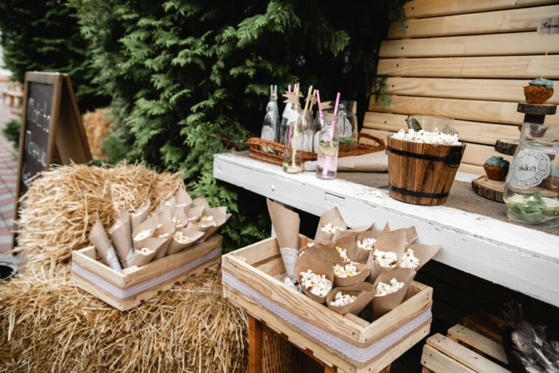 An outdoor popcorn bar with bags of popcorn all ready for guests to use