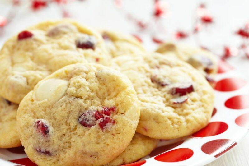 A red and white plate with cranberry or fruit cocktail cookies