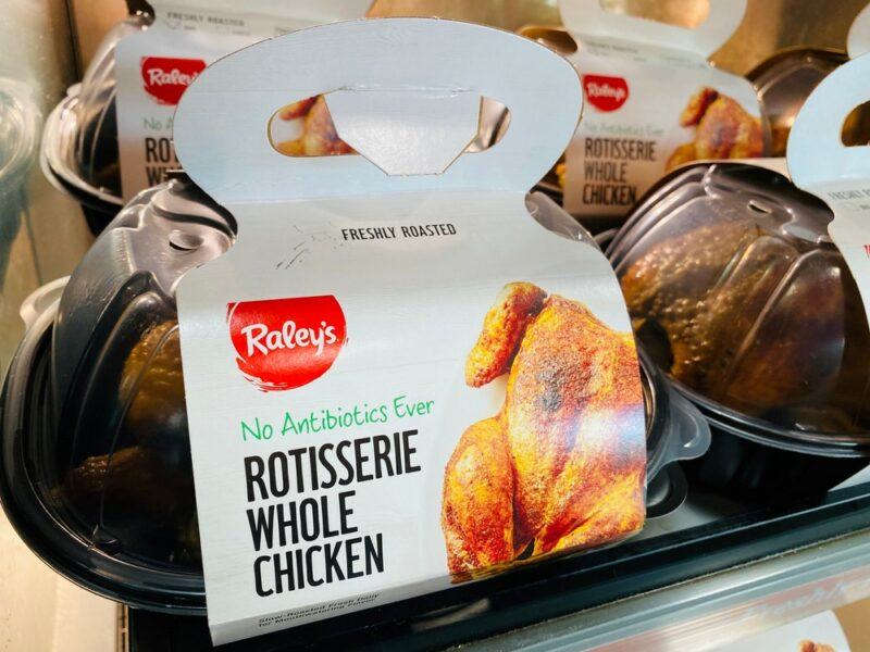 A cooked rotisserie chicken for sale in a store