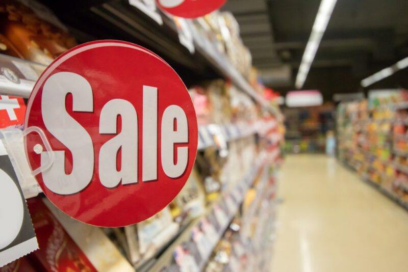 A sale sign in a store, highlighting the importance of planning your shopping well