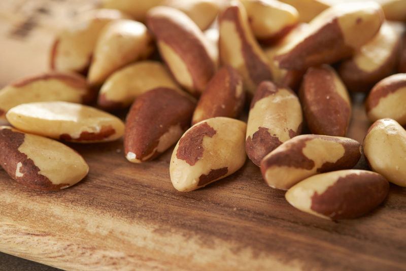 A pile of Brazil nuts on a wooden table