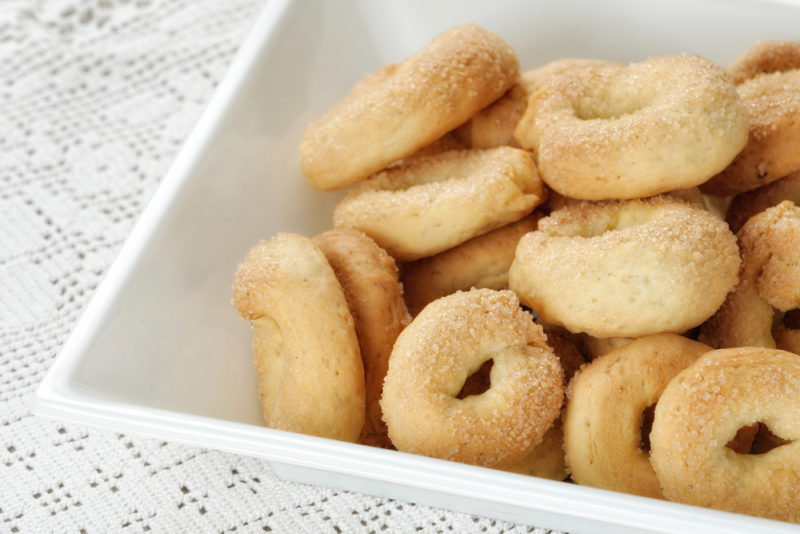 A square white dish that contains Italian biscuits