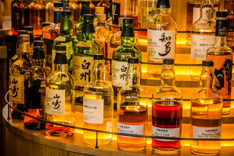 A selection of Japanese whiskey bottles standing at a bar